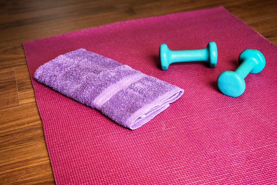 Yoga mat, weights, and a towel ready for a workout.