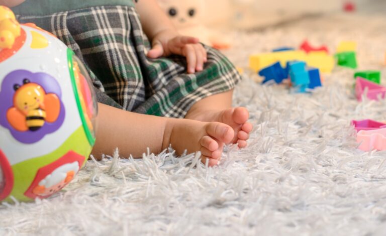 Toddler watching toys floor