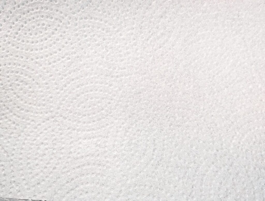 A close-up of a white paper towel texture.