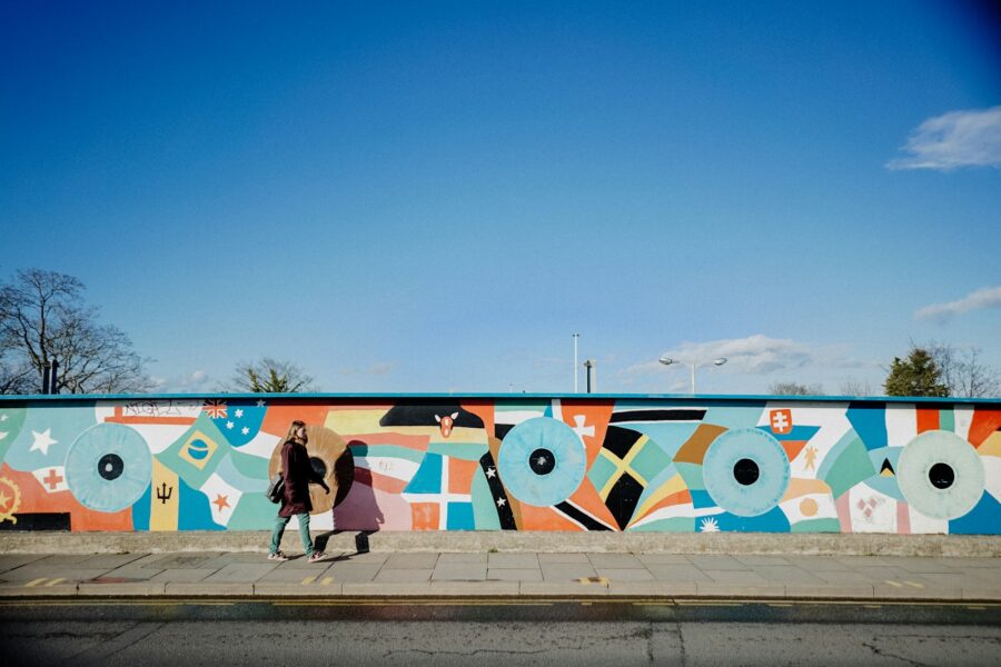 Colorful community mural wall people walking