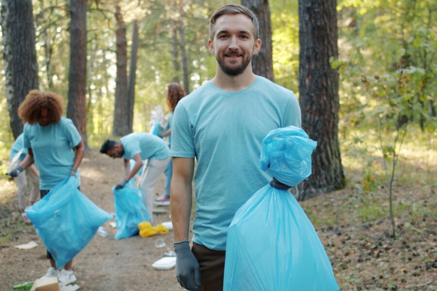 Parents kids volunteering park cleanup trash bags