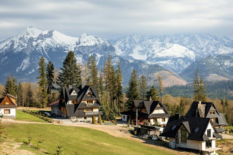 Alpine village wooden houses mountain peaks