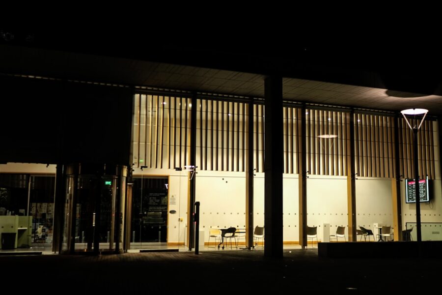 Night library students laptops books