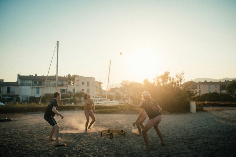 Backyard pickleball court players group playing spikeball beach