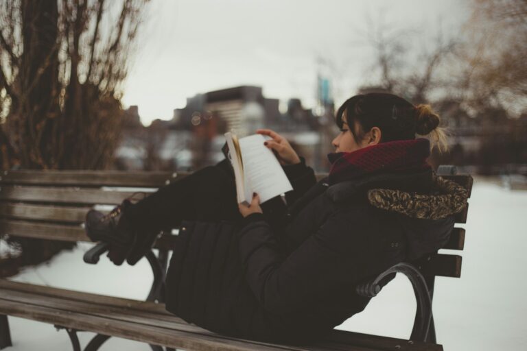 Woman walking park headphones cozy evening reading book