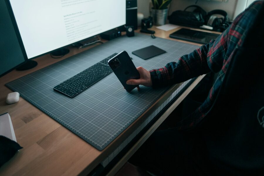 Person using smartphone minimal workspace desk