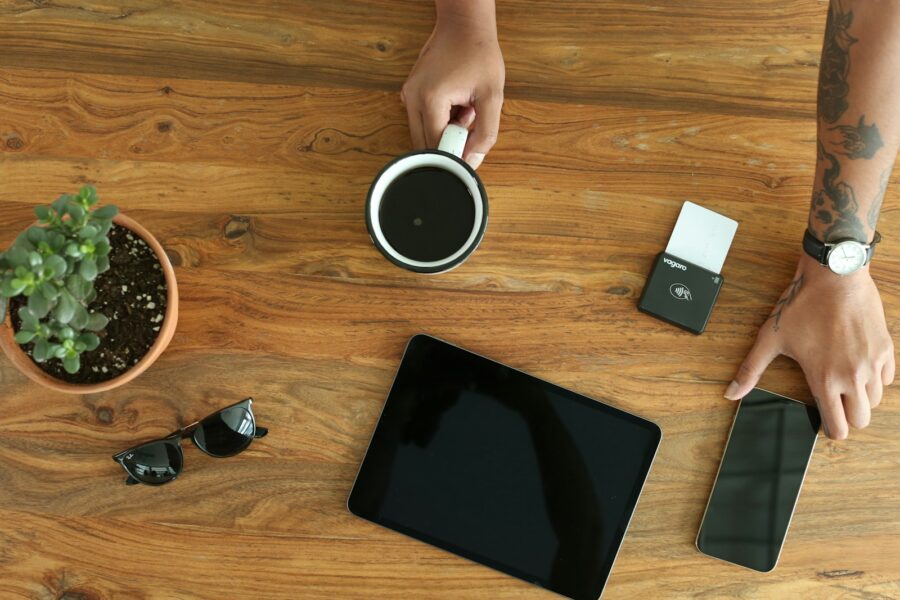 Person putting smartphone drawer wooden table