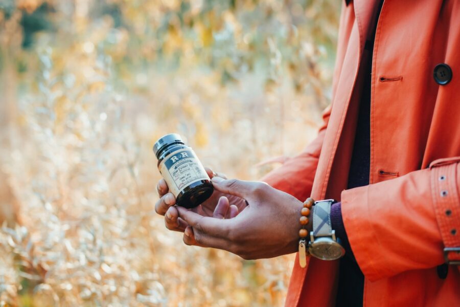 Person reading medicine bottle label closeup