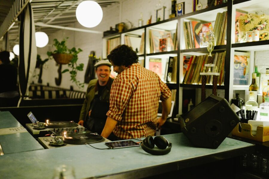 Two men at a dj booth with records