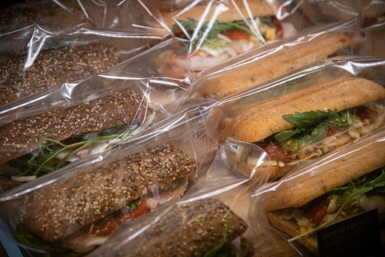 Packed sandwiches parchment paper roasted vegetable baguette closeup