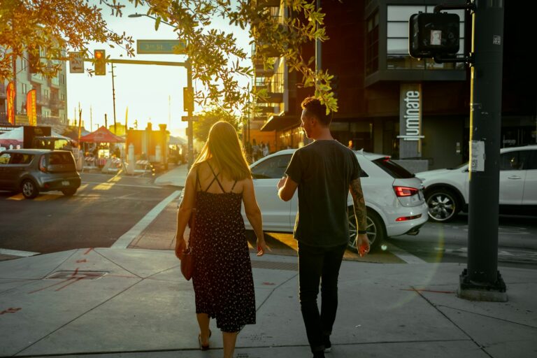 Person texting smartphone sofa couple walking city sunset