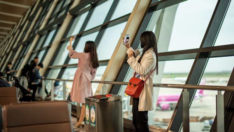 Airport lounge traveler phone boarding pass person using