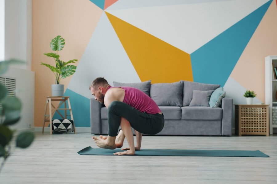 Man practicing yoga crow pose on mat