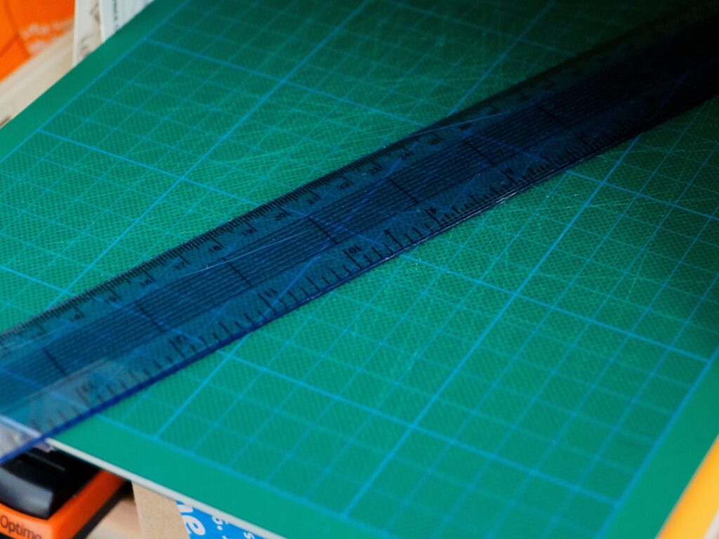 green and blue paper with ruler