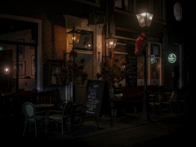 Nighttime city street walking couple cozy cafe window