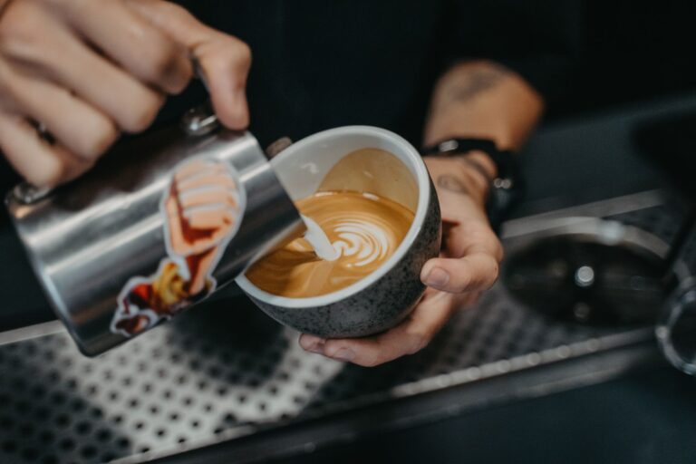 Barista pouring latte