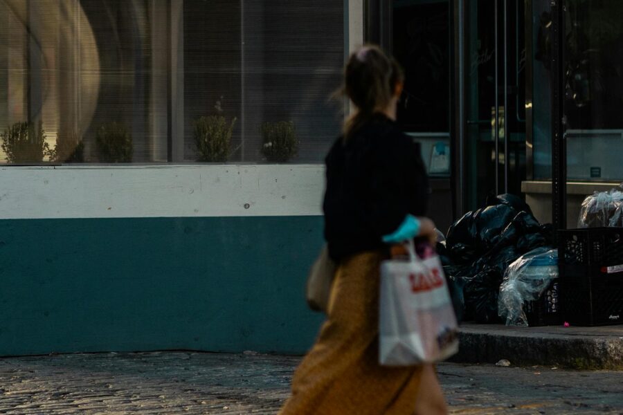 Woman walking after meal city sidewalk