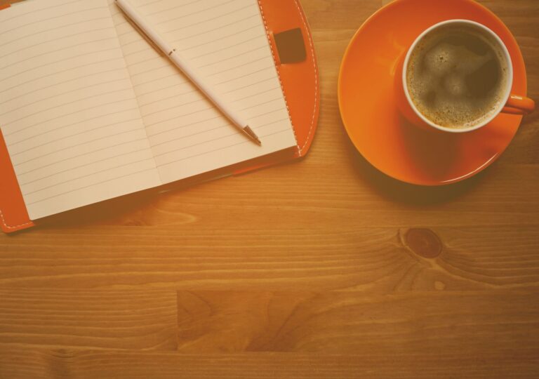 Open notebook coffee cup cafe table