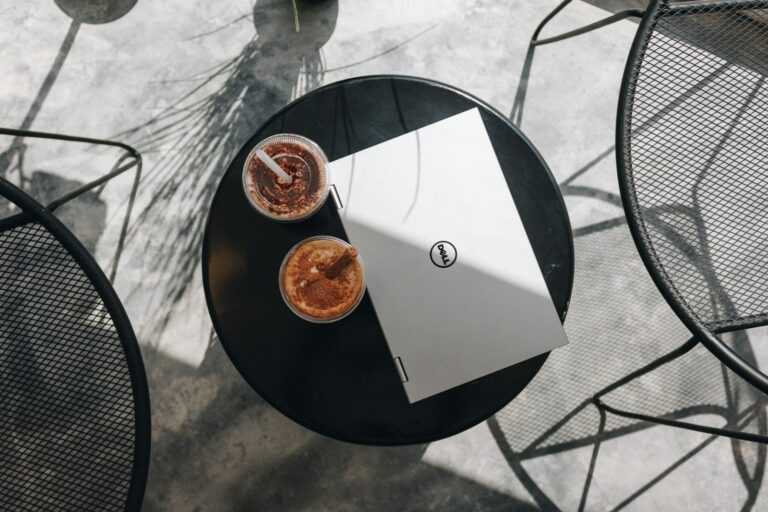 Open notebook coffee cup cafe table detail