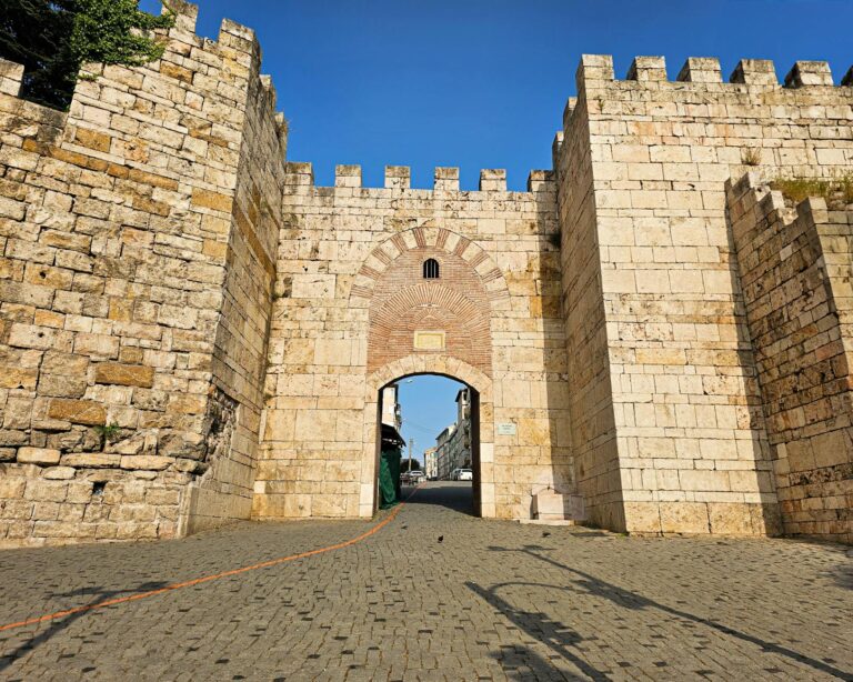 Historic city gate evening lights stone archway old
