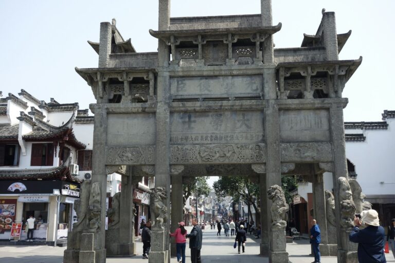 Ancient city gate stone arch pedestrians