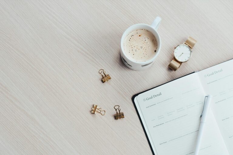 Desk planner pen coffee cup notebook detail