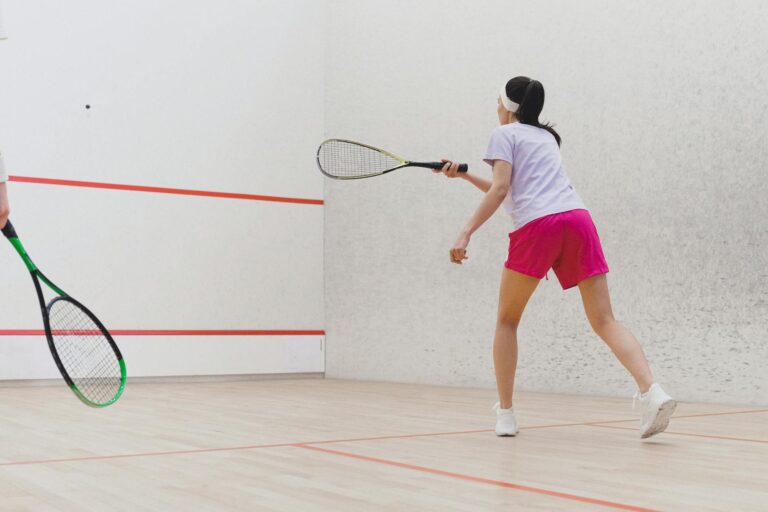 Indoor badminton court players squash court intense rally