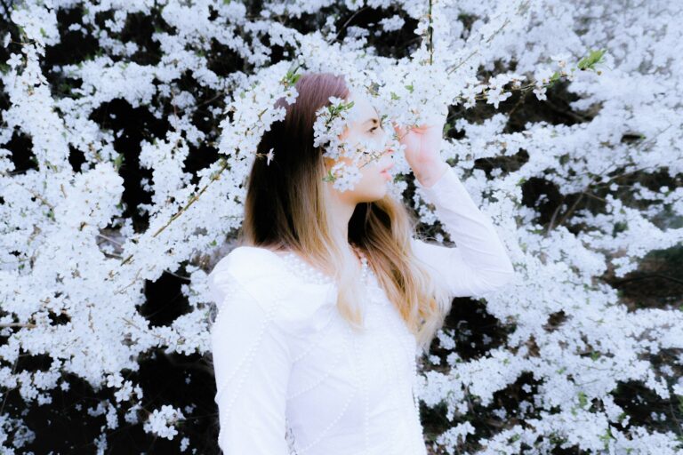 Woman sneezing tissue blooming trees spring pollen