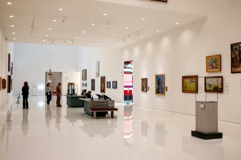 Museum gallery interior visitors benches paintings detail