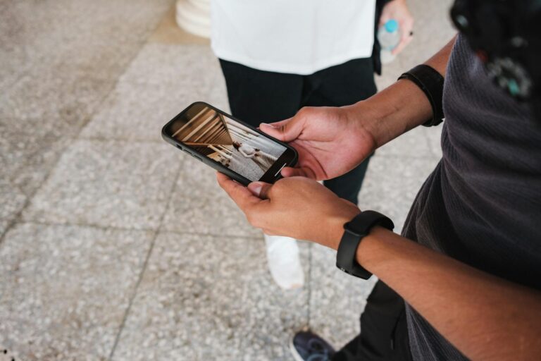 Person holding smartphone social media photos detail