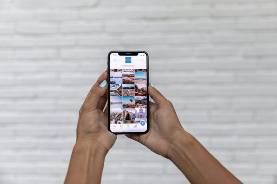 Person holding smartphone social media photos