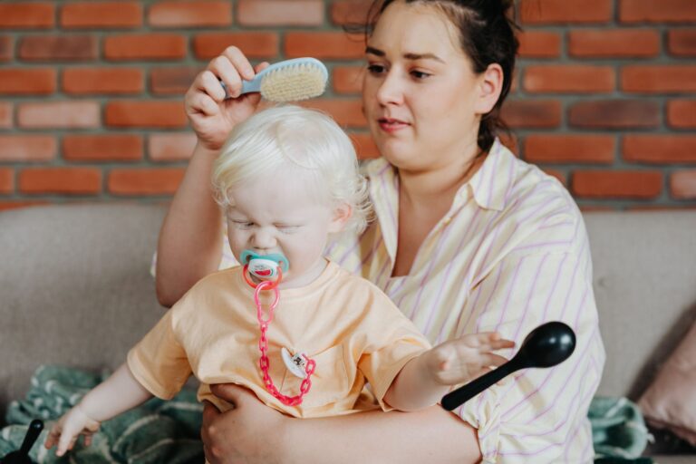 Child brushing cat