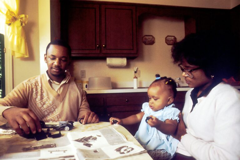 Parent child talking kitchen table about money detail