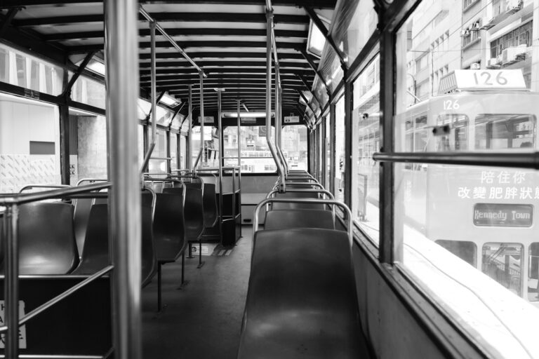 Tram interior commuters handrails city