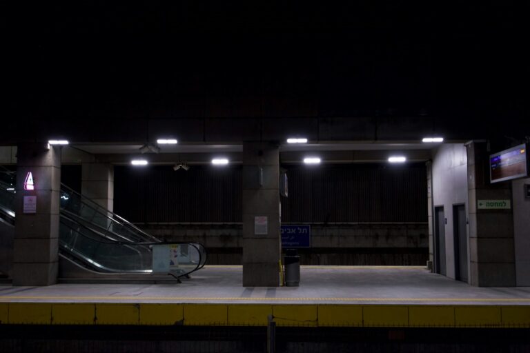 Bus stop night rain reflections metro station escalator
