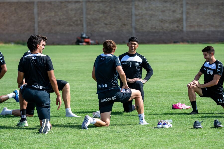 Team warm stretching football field