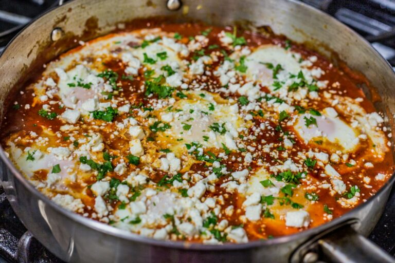 Egg skillet shakshuka tomatoes herbs detail