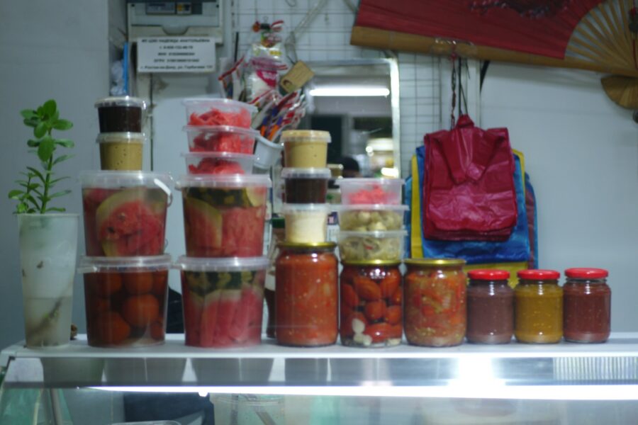 Organized fridge shelves glass containers vegetables