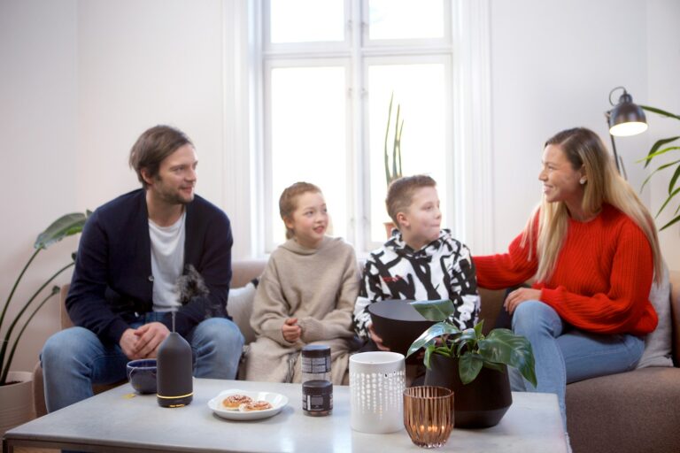 Family sitting sofa talking together detail