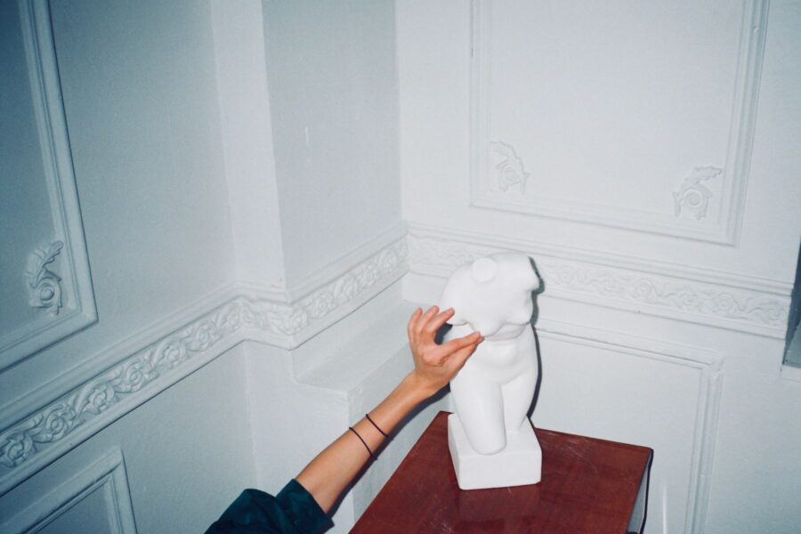 Hands touching sculpture