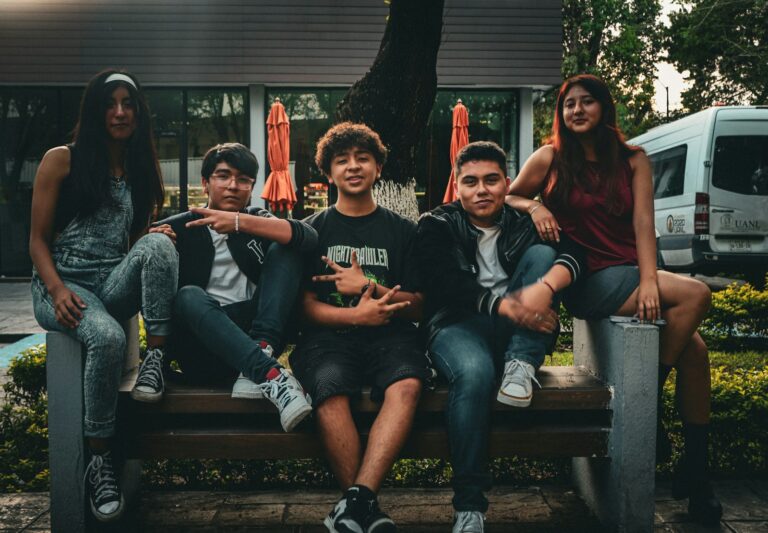 Teenagers sharing headphones
