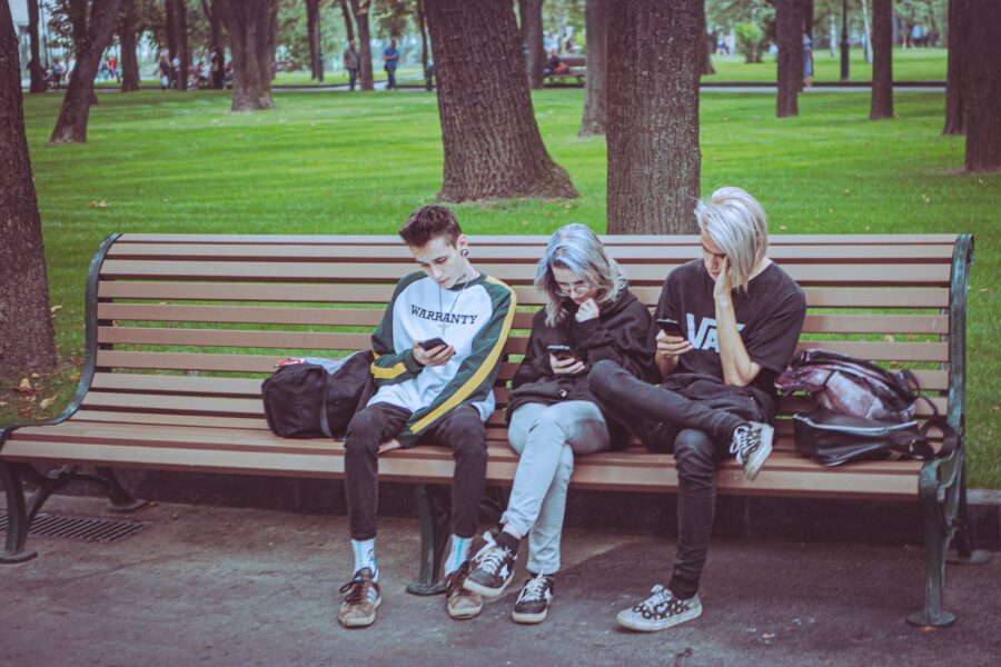 Teenagers sharing headphones