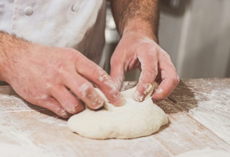 Hands shaping bread