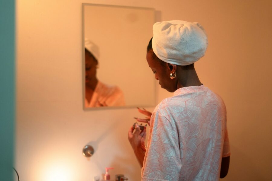 Woman applying moisturizer